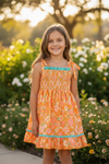 Orange ditsy floral w/mauve green ruffle trim smock dress. DRG60499 SOL