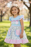 Lt.Blue floral printed dress with ruffle hem & egg applique. DRG60271 SOL