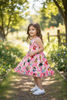 Pink character printed girls dress with ruffle hem. DRG60223 AMY
