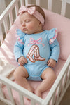 Lt blue boots applique baby bodysuit with floral ruffle on sleeves and ruffle butt. RPG61922 SOL