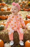 Pumpkin printed on pink baby romper with ruffle trim. RPG62349 SOL