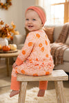 Pumpkin printed on pink baby romper with ruffle trim. RPG62349 SOL