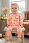 Pumpkin printed on pink baby romper with ruffle trim. RPG62349 SOL