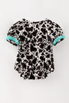 Cow printed baby romper with aqua ruffle hem. RPG64274 JEAN