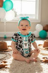 Cow printed baby romper with aqua ruffle hem. RPG64274 JEAN