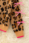 Leopard printed pullover sweater with fuchsia trim and lt. pink bows on sleeves. TPG60423 JEAN