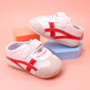 Off white infant tennis shoes with red design & velcro. YSA007R